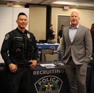 Photo of Posey visiting with Austin Police Department's recruiter at the event.