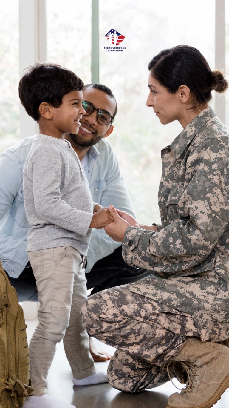 Military woman/mom kneeling down with family.